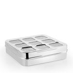 Square stainless steel masala box with a transparent lid and nine round spice containers neatly arranged inside.