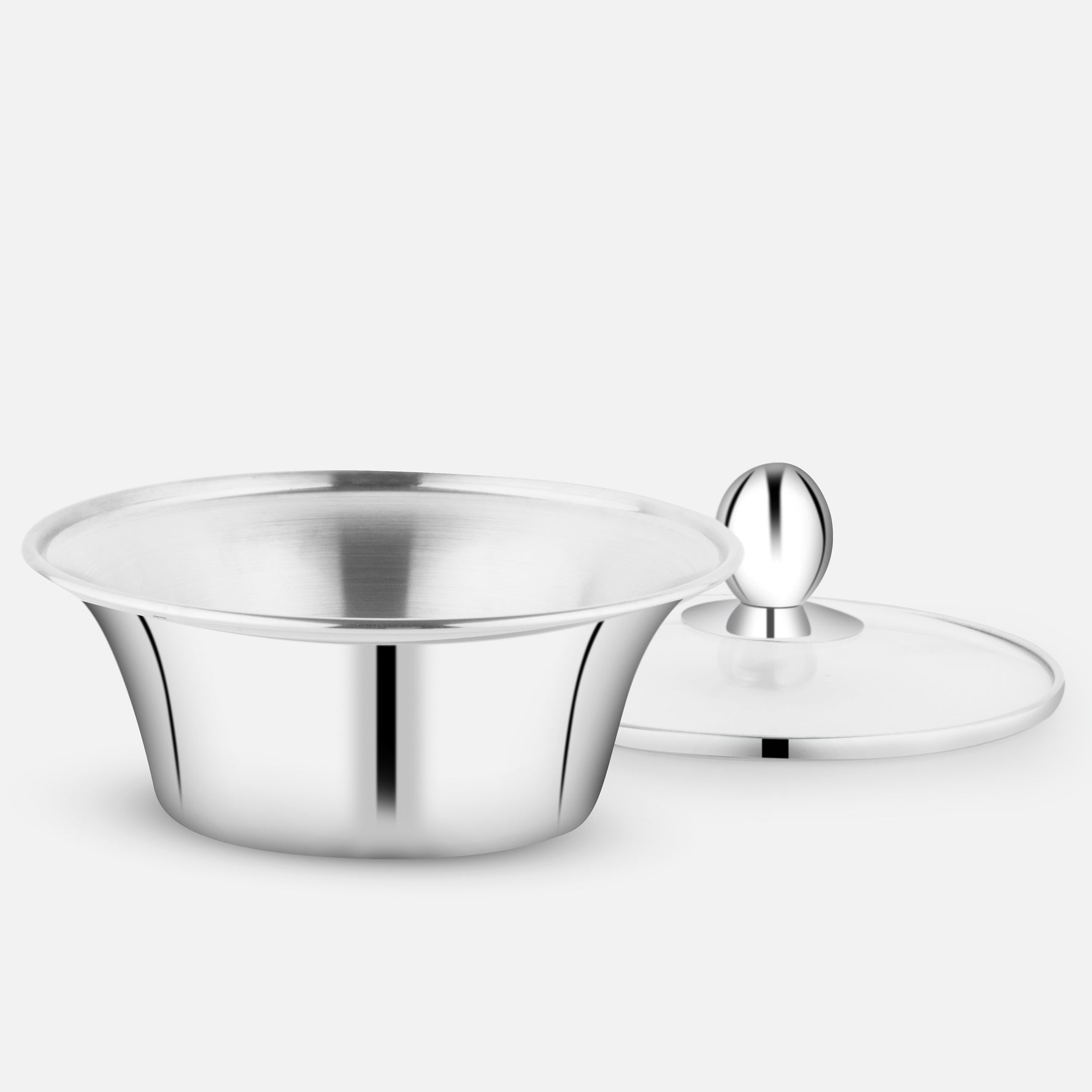 A stainless steel handi with a mirror finish, placed on a light grey background. The lid is placed beside the handi, showcasing its wide mouth and curved design, ideal for serving curries and traditional Indian dishes.